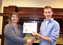 Neil receives his Service Certificate from Pam Byron Button, FAAS President